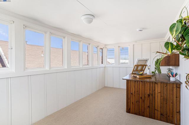 This is a gorgeous little upstairs sunroom, freshly carpeted and painted, with views of the hills.