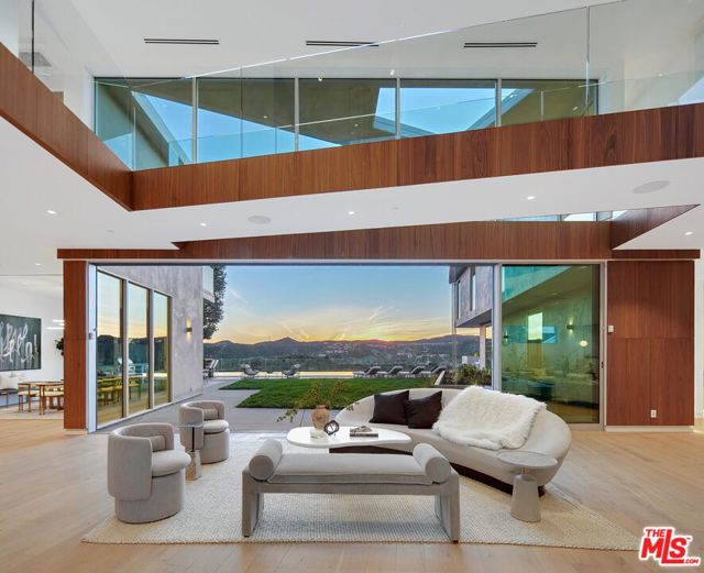 Located along the hillside of Bel Air, this newly constructed residence is highlighted by its unobstructed ocean views, designer details, luxury amenities, and intricate finishes. Secluded on a quiet cul de sac, the modern home spans over 7,600 square feet and includes 6 bedrooms and 7.5 bathrooms. A contemporary open floor plan encompasses the living room, dining room, and gourmet kitchen, equipped with chef-grade appliances, imported marble counters, custom walnut cabinetry, and a substantial island. Walls of glass wrap the home and open to the impressive rear grassy yard, complete with oversized infinity pool and spa, fire pit, outdoor kitchen, and multiple patio areas, ideal for taking in the sweeping views. Secondary ensuite bedrooms are located throughout the home with the primary suite positioned privately, featuring a walk-in closet, spa-grade bathroom, and balcony to take in the perfect elevated vantage point. Additional features of the property include an architectural glass-clad staircase and catwalk, indoor/outdoor entertainment room, steam room, multi-zone heating and cooling systems, smart home technology, electric vehicle charging within the attached 2-car garage, and a bonus multi-purpose room, already prepped for any future recreations or endeavors desired.