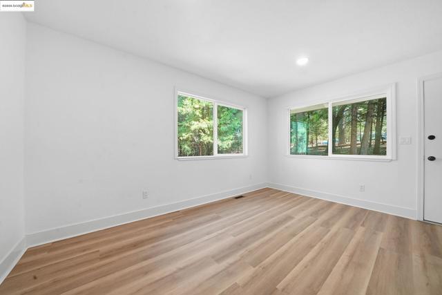 Spare room with light wood finished floors and recessed lighting