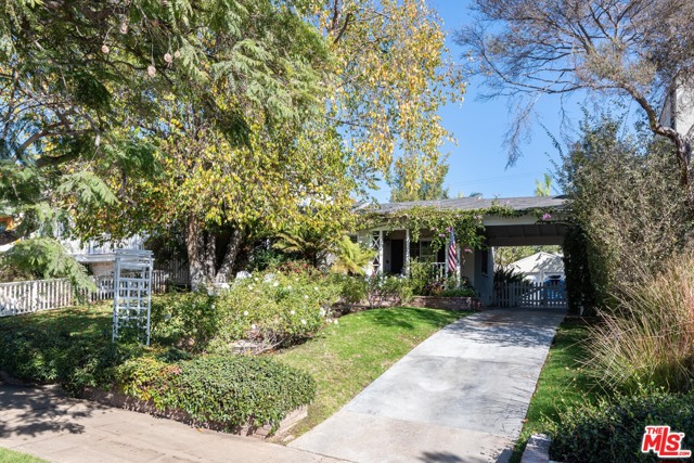1116 Monument Street Pacific Palisades, California Ideally located just a few doors up from the iconic Palisades Village, this storybook Ranch style home provides the Palisades lifestyle you've been waiting for. Access all the Village shops, restaurants, schools and amenities within minutes. Enter from the charming brick front porch into the light filled formal living room with wood floors and wood burning fireplace. The dining area beyond the living room leads into the kitchen with Black Absolute granite counters and stainless Frigidaire appliances. The family room with fireplace opens through French doors to the lush backyard. There are two bedrooms and two baths on the main level, and a large master suite upstairs with sumptuous bath, fireplace and walk-in closet. The resort-like backyard with terrific entertaining possibilities has a cool Hawaiian vibe and encompasses two separate seating areas with a firepit and a private spa. Parking is available in the 2 car garage and on the long driveway.