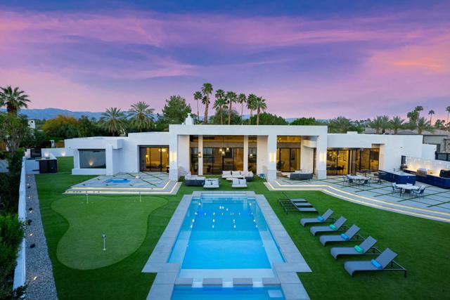 Nestled within the prestigious Clancy Lane Estates of Rancho Mirage, this Exquisite Furnished Home exemplifies Modern Luxury seamlessly marrying comfort with Contemporary Design Elements. You are greeted by an expansive, open concept Living Space with sophisticated finishes. The heart of the home is the custom-designed Gourmet Kitchen, a haven for Culinary Enthusiasts boasting a Lacanche Oven, custom hood, Wolf & Sub Zero Appliances & custom cabinetry centered around an oversized Island. Adjacent, a cozy Den ideal for entertaining, the spacious Dining Room features a well-appointed bar & effortlessly transitions into the expansive Living Room distinguished by a striking floor-to-ceiling marble Fireplace and a hanging Lounger beckoning for relaxation. Features; a State-of-the-Art Control 4 home Automation System integrating lighting, audio/video, climate control, shades & security features. Surround sound, new Roof, Owned Solar panels & Tesla wall power. Floor-to-ceiling windows and doors for a seamless indoor-outdoor flow. Primary Suite with its Spa-inspired amenities, a teak custom Shower, infrared Sauna, Bauformat closet and Japanese toilet. Outside, the resort-inspired Oasis complete with Dining area, BBQ & Pizza Cook Center, an Ozone Pool-Spa & a 2nd - 12 person Spa. Picturesque Mountains. Enjoy the outdoor amenities; Pickleball court, Putting Green ~ all astro turf yard. Completing the Home a 3-Car A/C equipped w/Gym, Storage and Bev. Fridge. A desert Dream home.