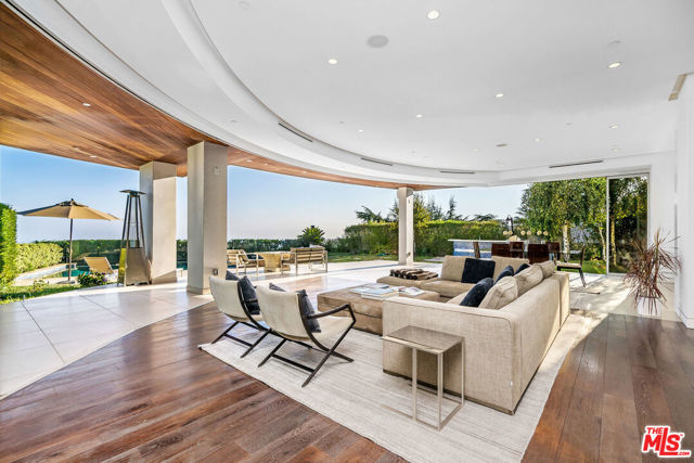 2235 Hercules Drive Los Angeles, California This stunning modern architectural estate is an entertainer's dream house, boasting an indoor/outdoor living experience with unobstructed views from Downtown Los Angeles to the Pacific Ocean. The home features a custom circular living area, a sleek modern European style kitchen with state of the art appliances, an entertainer's bar area, home theatre, office, and maid's quarters. The master suite includes a two-sided fireplace, reflective privacy glass, a private grand balcony to enjoy panoramic views, and a master bath with floor to ceiling marble, floating tub, rainfall shower/steam, and his/her bath closets. Experience the glass elevator on your way down to the lower level walk-in wine cellar and ten car subterranean garage. The unique exterior shape has a vast stainless steel trim, meticulously manicured backyard, Koi pond, and an infinity pool/spa.