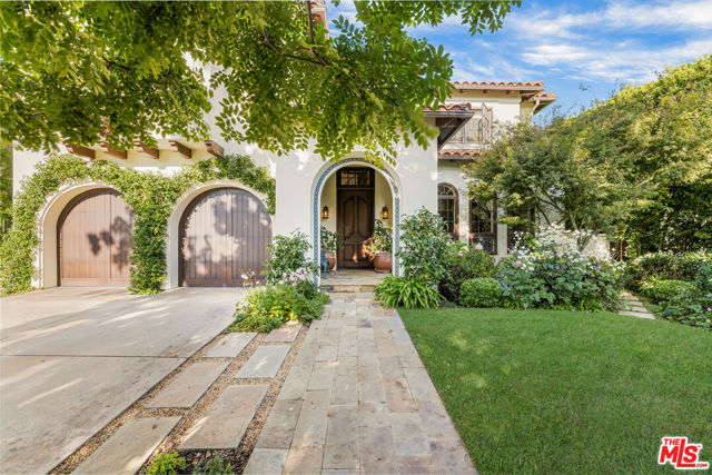 Welcome to this warm and inviting, one owner, custom home combining traditional Spanish and Mediterranean elements in the heart of Santa Monica on a nearly 9,000 sf lot. Wonderful light filled spaces, high ceilings, beautiful archways and flowing floor plan make this a special offering in a prized north of Montana Ave. location. Enter into the double-height foyer which welcomes you into a spacious open living room with hardwood floors, elegant fireplace and built-in shelving. The kitchen, formal dining room, breakfast nook and adjacent family room all open up to the gardens. Totaling five en-suite bedrooms and a powder room, with four generous bedroom suites upstairs, highlighted by a large primary suite with vaulted ceilings, large bathroom, dual closets, separate seating lounge and private balcony overlooking spectacular gardens, trees, large pool and spa. The grounds are extremely private and feature a magnificent wood-beamed trellis with built in BBQ and dining area underneath. Oversized two car garage leads directly into the house and augmented systems include a water filtration system, ozone pool and backup generator. The home sits on a peaceful, treelined street with sidewalks in close proximity to the markets, shops and amenities of Montana Avenue.