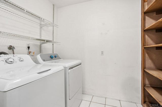 Upstairs laundry room comes with new dryer & newer washing machine. Storage cabinets & shelv8es.