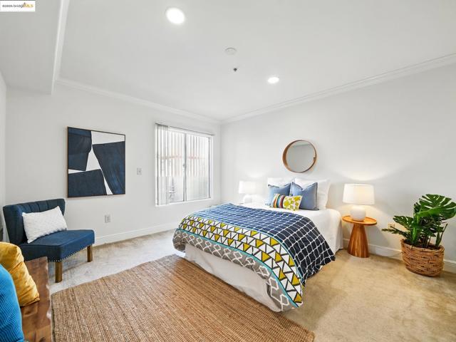 Carpeted bedroom with crown molding and recessed lighting