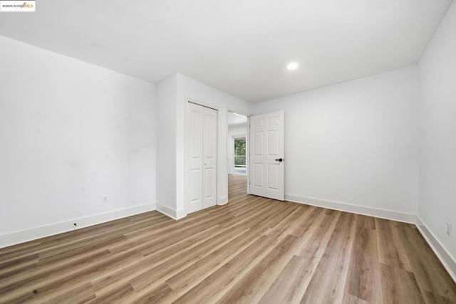 Spare room featuring light wood-style flooring and recessed lighting