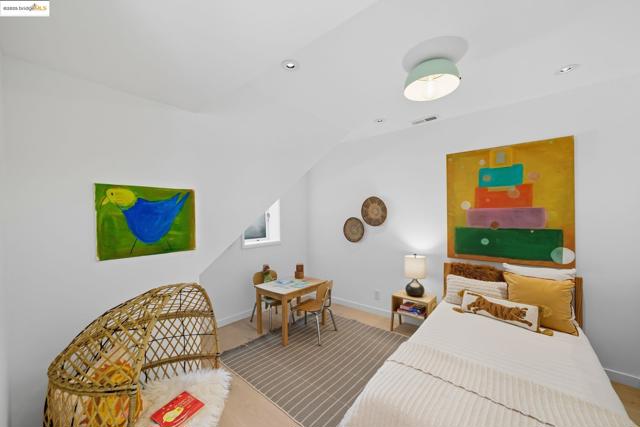 Bedroom with vaulted ceiling and recessed lighting