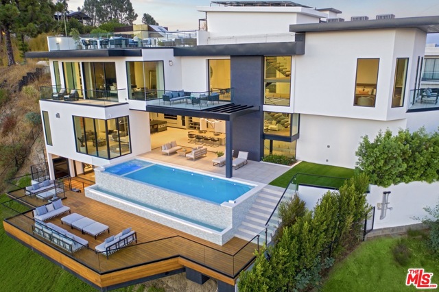 1201 Linda Flora Drive Los Angeles, California Set upon the hills of prime Bel Air, this modern masterpiece boasts meticulous design and attention to detail so often overlooked in new builds today. Offering textured views of Santa Monica Mountains, Getty Center, Ocean & San Gabriel mountains. Step inside this elegant, light & open home and experience the definition of luxury living. Take in breathtaking views from the first floor featuring a motorized Fleetwood slider opening to the infinity pool & spa floating in the sky. Create in the designer kitchen w/ Miele appliances and enjoy in the grand dining area. Lower floor offers the pinnacle of entertaining w/ screening room, wine room, full bar, gym, deck & guest quarters. Second level offers 3 impressive suites including breathtaking master w/ one of a kind views & luxurious master spa & designer closet. Upstairs find a serene rooftop balcony unmatched in Bel Air w/ fireplace & BBQ. Features 4 stop elevator & designer finishes including Missoni wall paper & soaring limestone walls.