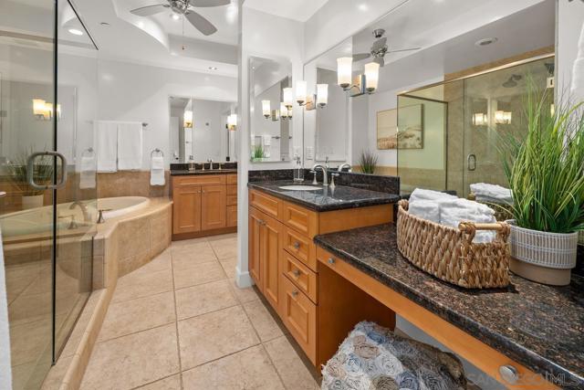 Generously sized primary bath with a soaking tub, his and her vanities, and a walk-in closet.