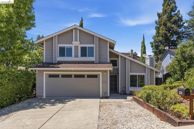 Contemporary two-story residence with a pitched roofline and an attached two-car garage