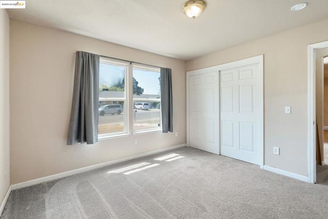 Unfurnished bedroom featuring carpet flooring and a closet