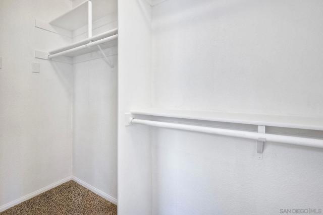 Primary bedroom features a spacious walk-in closet (freshly painted) with attic access.