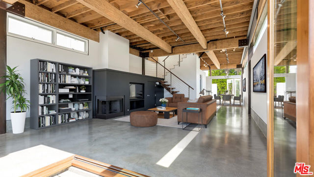 Prime Abbot Kinney adjacent location in Venice! Dramatic 2 story loft-style live/work space in the heart of Venice-surrounded by restaurants, shops and galleries. Just steps from Abbott Kinney, Rose Ave, and the beach. Warm woods, polished concrete, high exposed-rafter ceiling -embrace the modern Venice aesthetic. Spacious gourmet kitchen. Dramatic, open stairwell leads upstairs to 3 bedrooms/office spaces. Total 2.5 baths. Massive accordion doors open to lush landscape, merging indoors & outdoors. Two large patios within the gated compound. Walk score of 91 "walker's paradise". Interior space is approx 1,755 sqft. Includes 2 parking spaces (tandem) in a  secure garage/carport area. Completely separate & w/ a separate entrance is a small guest unit above the garage/carport. It is currently leased separately with 1 parking space.Central Air Conditioning and Heat.  Showings by appointment only.