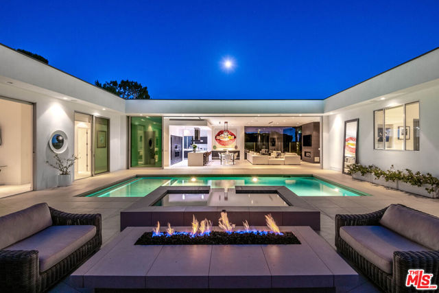 1479 CARLA Beverly Hills, California INCREDIBLE $2 MILLION PRICE REDUCTION! SELLER IS MOTIVATED TO SELL! Extraordinary Trousdale Contemporary designed by Jon Mandl with spectacular city views. The architecture of this fabulous home delivers clean lines with walls of glass & Fleetwood doors throughout that seamlessly fuse to integrate interior & exterior spaces & offer the ultimate Beverly Hills lifestyle w/ideal space for entertaining in grand style. Incredible pivot front door to formal entry & spacious formal living rm & walls of glass to stunning views. The natural light enhances a stunning kitchen, dining area, & family rm that combine for a magnificent great rm. The kitchen is complete w/long center island, quartz countertops, & professional Miele appliances. The exceptional master suite w/large walk-in closet & luxurious bath w/dual vanity, soaking tub, & steam shower. 3 add'l bdrm suites. Yard is complete w/patios, viewing pavilion, grass area, fire pit, & sparkling pool & spa, all overlooking the shimmering vistas.