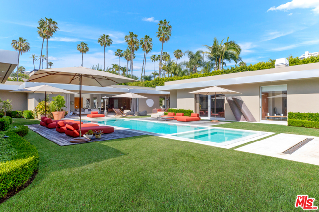 450 Doheny Road Beverly Hills, California Beautifully situated behind gates in the most prime section of Beverly Hills, enter through a large private motorcourt to a sprawling approximately 9,000 sf modern estate on two-thirds of a flat acre, completely remodeled with the highest quality and beautiful finishes. Featuring terrazzo floors, high ceilings, a large double sized living room, formal dining room, spectacular screening room, gourmet kitchen, 5 bedrooms + staff. Walls of glass open to a beautiful secluded backyard with large in-ground infinity pool, outdoor kitchen and living room, and grassy areas, creating the perfect indoor/outdoor flow and lifestyle. Incredible master suite with dual walk-in closets and baths, steam, etc. Very stylish, sophisticated, and chic, completely secluded by hedged walls and gates. Shown to pre-qualified clients only.