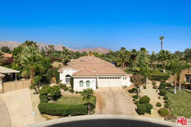 50025 Monteloma Court La Quinta, California Welcome to La Quinta's secret gem at the beautiful Mountain View Country Club! Set on approximately a half acre of land, this unique home sits at the far end of a private cul-de-sac. Upon entering the courtyard, you will be welcomed by a grand rotunda foyer which sits beneath a striking custom chandelier. You'll notice the impressive 12 foot ceilings as the foyer opens up to the great room, dining room, kitchen and family room. The luxurious great room features a wet bar, fireplace, media center, and an extra room which can be used as a multi-purpose area. The gourmet kitchen boasts granite countertops, maple cabinets, built-in refrigerator, and convection oven. The recently updated travertine flooring throughout the entire residence will lead you through two master bedrooms. The first which features a huge walk-in closet, roman tub, shower, and direct access to the expansive backyard. Out back you will be wowed by one of the largest private outdoor areas in the entire community! A breathtaking meandering pool and elevated spa with waterfall is surrounded on either side by two expansive yards, leaving enough open space to make it your own. Use your imagination! The rear covered patio leads to a large fire pit area, great for entertaining among the numerous palm trees while stargazing on those lovely dessert evenings. You will also notice the large courtyard casita, which offers a great alternative for family and guests to escape to their own private and relaxing location. Nestled in one of La Quinta's most desirable gated communities, with a plethora of exciting and unique amenities, it is needless to say that this home is certainly one of a kind! Come take a look for yourself!