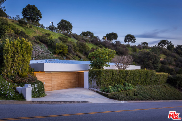 1106 N HILLCREST Road Beverly Hills, California Located on the most sought-after street in Los Angeles, "Billionaire's Row," this spectacularly crafted contemporary estate offers city and ocean views and exudes quality and refinement. A stunning zero-edge pool, substantial Ipe outdoor decking, bespoke Poliform fixtures and finishes, subtle indoor LED lighting, and lush and tranquil landscaping complete this impressive single story estate. With an open floor plan and floor-to-ceiling glass doors, the home boasts exceptional indoor-outdoor living. Secure and private, this is a unique opportunity for the most discerning owner.