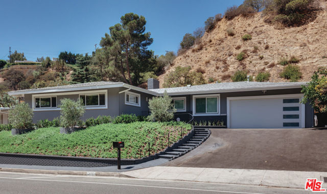 2315 Coldwater Canyon Drive Beverly Hills, California Walk in and you will immediately be impressed! This home brings the "WOW!" Thoughtfully and beautifully remodeled to the last detail with modern amenities, this move right in, mid-century modern gem has a Zen vibe and energy that perfectly captures the Los Angeles lifestyle! This sleek, sexy and bright single story, gorgeous home is filled with natural light, an open floorplan and a fully remodeled kitchen featuring Caesarstone counters, all LG appliances, a double oven, 2 sinks and an open breakfast counter. The laundry area has stacked LG washer/dryer, sink, storage and area for folding. Multiple flexible living and dining areas all open to the outdoor entertainer's patio for seamless, indoor/outdoor living and entertaining. Slide open the glass doors, extend the electric, automatic awning, which covers the whole outdoor sitting and dining area, and enjoy Los Angeles weather and living! The spacious Primary Suite is separated from the 2 guest bedrooms for utmost privacy and features a spa-like bath with dual sinks, frameless, all glass shower, mirror with multiple light settings, plus a finished, generous walk-in closet. Both guest bedrooms are spacious, with walls of closet space. Fully remodeled guest bath has dual sinks, frameless glass shower and deep soaking tub. Beautiful manufactured floors throughout will withstand indoor/outdoor living and entertaining for years to come! Electric fireplace can be enjoyed year round. Gorgeous, lush landscaping on drip system, with automatic sprinklers that includes 3 beautiful olive trees. New central HVAC and tankless water heater, recessed LED lighting throughout, double paned windows, tons of closet and storage space, centrally monitored security system interior, Ring Security system outside. Attached, finished, 2 garage with new garage door and new Genie motor. New asphalt driveway. Security mailbox. Ideally located between Beverly Hills and Sherman Oaks, close to Tree People, Franklin Canyon Park and Coldwater Park. 9 minutes to Beverly Hills, Ventura Blvd and the famous Glen Center. Immerse yourself in the luxury, beauty and great flow of this gorgeous home nestled in nature!