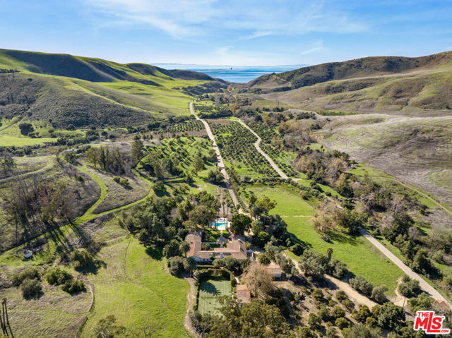 Encompassing over 3,100 acres of majestic rolling hills + natural open space along the Gaviota Coast, The Hacienda Ranch at El Rancho Tajiguas embodies the spirit + history of Old California. At the heart of this magnificent ranch is the historic Hacienda Residence, originally designed by George Washington Smith + later additions by Cliff May, inspired by turn-of-the-century California adobe architecture. The Hacienda sits prominently among over 970AC of rangeland, 585AC of agricultural operations, 100AC of riparian area, & 1,600AC of open spaces/wildlands. Property is supported by 15 wells, 6 reservoirs & creek diversion weirs, 2 cottages, manager's home & 14 employee homes. 25 underlying parcels provide land use flexibility & may offer tax benefits via donated conservation easements.