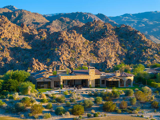 The ultimate desert estate and car lovers dream at the Reserve! Newly built in 2020 on over an acre with no expense spared this 8,457 sq. ft. home checks every box! Featuring 5 bedrooms including a master wing and a 3 bedroom guest house. 4 full baths, plus 4 powder rooms, incl. an outdoor shower and infrared sauna. Gated entry into large courtyard with fountains and garden. Stunning great  room with towering wood beamed ceiling, floor to ceiling stone fireplace, and step down custom granite top bar. Gourmet kitchen with double islands, state-of-the-art appliances, butlers pantry and prep kitchen. Adjacent is a breakfast nook with walls of glass, fireplace and media. Beautiful formal dining room with built-in buffet room with wet bar and climate controlled red and white wine displays. Spectacular views from all rooms, custom finishes throughout. Imported Italian porcelain tile flooring flows outdoors as well. Accommodations include the most incredible master wing with fireplace, media and sitting area, coffee bar, his and her offices, and private TV room with built-ins. His and her vanity bath, commodes and closets. Three bedroom guest house with living room fireplace and media, kitchenette with coffee bar. Wonderful outdoor living area with fireplace and media. Dining rotunda with the most amazing BBQ kitchen  Custom infinity pool with tanning shelf and raised spa. Putting green and the man cave garage with gym and parking for 10 cars. Offered furnished per inventory.