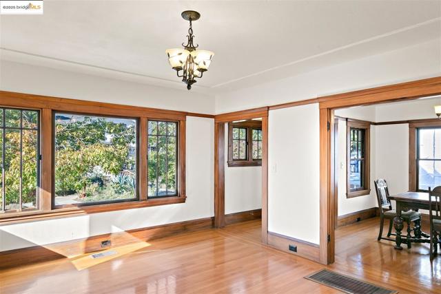 Unfurnished dining area with a chandelier and wood finished floors