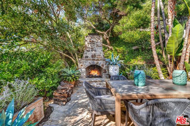 1090 RAVOLI Drive Pacific Palisades, California A private oasis in the Riviera area of Pacific Palisades, this home was previously the hideaway of multiple major Oscar award winners and royalty. This beautiful Mediterranean villa, known as Villa Delle Fontane, is a garden paradise with numerous lounging alcoves. Exuding European charm, the house is perfect for living the indoor/outdoor lifestyle. Fountains, wood-burning fireplaces, mountain views, lush vegetation, fruit bearing trees, and outstanding privacy make this home the ideal choice for a getaway from the hustle and bustle. Close to Palisades Village, Brentwood's Country Mart, and Santa Monica's Beaches. This unique custom villa combines the best of materials with quality craftsmanship, from a hand-laid cobblestone driveway, to floors made from 16th and 17th-century reclaimed French pavers, Australian fir wood, as well as imported limestone delicately accented with custom mosaics. Countertops of French limestone and Italian marble and lace-like forged iron work, transport you to another era of hand-crafted elegance. The enchanting gardens, recently re-imagined by the genius of famed landscape architect Jay Griffith, are lush and meandering, with fountains scattered throughout. This villa has two large primary suites and a guest suite upstairs, two additional bedrooms downstairs, a library (which could be an additional bedroom), an elegant oversized living room with a hand-carved limestone mantle, formal dining room and a huge eat-in kitchen with a spacious center island. Windows and doors look onto gardens or views of Will Rogers Polo Fields and the Santa Monica Mountains with stunning sunsets. Simply amazing and unique! If you're looking for something very custom, unlike what you see everywhere else in town, this is for you! Best buy, check recent sales nearby.