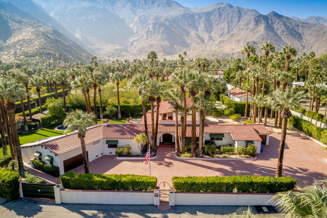 MAJOR PRICE ADJUSTMENT! Experience the epitome of luxury living in this unique and meticulously restored 2-story Spanish Colonial nestled on approximately 1 acre of prime land within the highly sought-after Old Las Palmas neighborhood of Palm Springs. Originally stripped down to its core in 2001, this property has since been thoughtfully expanded by acquiring an adjacent half lot, creating a private family haven that radiates timeless elegance. No expense has been spared in the restoration of this architectural gem, evident from the moment you step inside. Every detail exudes opulence, a testament that must be witnessed firsthand to truly appreciate. With its distinctive Spanish Revival design, this home channels the spirit of a WALLACE NEFF masterpiece. This spacious 5-bedroom, 9-bathroom dwelling offers an expansive 6,577 square feet of living space, featuring not one but two master suites, three guest suites, a dedicated theater room, an inviting upstairs sitting area, and a well-appointed exercise room. Step outside, and you'll be greeted by a pristine saltwater pool, resplendent in ceramic blue tile, complete with a tanning bed and a built-in spa. The meticulously manicured grounds boast breathtaking views and house a delightful fruit orchard alongside a collection of 56 majestic palm trees. For those with a passion for automobiles, this property is a dream come true. It features 3 attached garages, plus a separate 910sf garage w/12-foot ceilings and its own driveway.