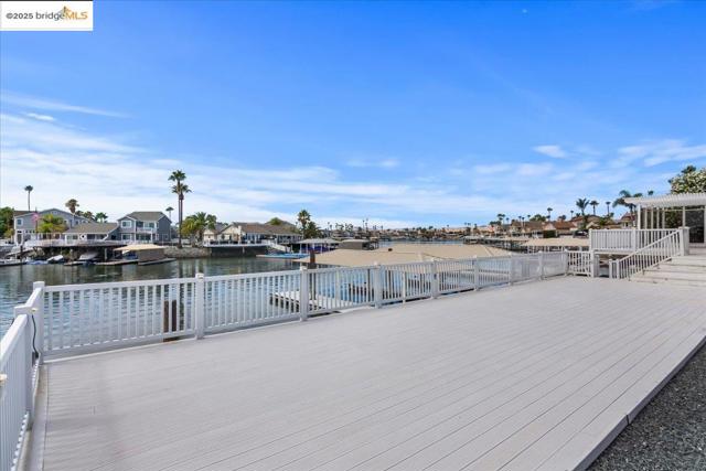 Deck featuring a residential view and a water view