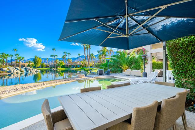 Outdoor dining with lake and pool view