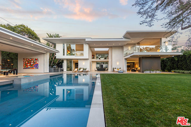 Located north of the famed Montana Avenue in Santa Monica, minutes from the beach, this exquisite contemporary estate exudes seclusion, wellness, and best-in-class design. New state-of-the-art construction, the property includes 7 bedrooms and 12 bathrooms across the main residence with a separate adjacent pool house. Heightened ceilings and dramatic walls of glass span the main level with a floor plan that seamlessly transitions from each room to the next, including the formal sitting room, separate family room, elite show kitchen, and a fully equipped industrial chefs-kitchen that leads into the formal dining room. Motorized doors open to the zero edge pool/jacuzzi exterior terraces and expansive lawn. This home offers best-in-class smart home technology system operated through voice activated Josh AI with all the amenities a buyer would hope for. Upstairs, a gracious primary suite takes advantage of the home's lush garden views while 3 more spacious ensuite bedrooms round out the floor. On the lower level, a resort-level spa/wellness center comes complete with an illuminated Himalayan salt wall, a redwood cedar sauna with oversized tropical rain shower with aromatherapy steam features, plunge pool, a meditation platform surrounded by a moat, and a massage therapy room. Added luxe features and details include, office, dual elevators, elite-level gym, multi-car garage, 1,157sf of basement flex space, and air and water purification systems. Intricate designer touches elevate the property such as Waterworks faucets and shower trims, Julien and Franke stainless sinks, European Oak floors, a Lynx pizza oven and grill, and artisan marble throughout.  The estate is the ultimate combination of elegance, style and functionality. One of the most exclusive compounds to ever hit the market in Santa Monica.