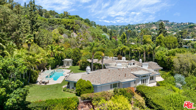 Located in the heart of Trousdale Estates sits a 2 acres promontory, tucked between lush landscape with explosive views. As you enter through the private gates, you are met by an oversized motor court which showcases the single story, 11,000 square foot primary residence, with grandfathered 18-foot roof pitches, 5 bedrooms and 9 baths. Additionally, a detached guest house which includes 3 beds, 2 baths, a kitchen, dining room and living room. Being one of the largest properties in Trousdale, not only is it primed for a turnkey buyer, but has potential to be a world-class development site.