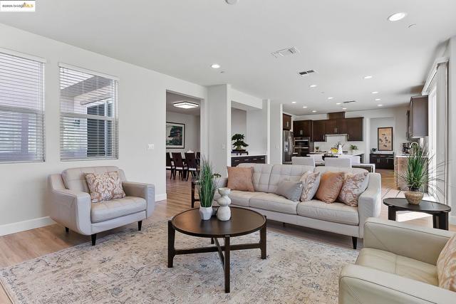 Living area with light wood-style flooring and recessed lighting
