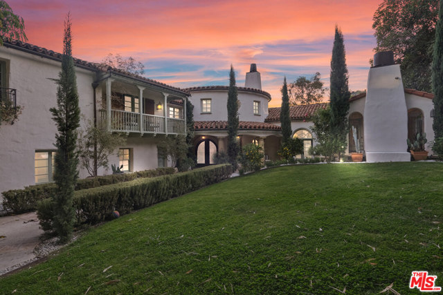 9308 Readcrest Drive Beverly Hills, California This Spanish Revival estate, known as Casa de Seis Palmas, has a storied Hollywood past and offers utmost seclusion and privacy behind lush landscaping. This luxurious celebrity hideaway has been home to actress Marion Davis, record mogul Ahmet Ertegun, and supermodel Tyra Banks. The home boasts an abundance of light and beautiful details like travertine stone and wood-planked floors throughout. The spacious living room is framed by a majestic vaulted wood-beamed ceiling, French doors, and grand floor-to-ceiling windows. A chef's kitchen comes replete with custom cabinetry, large center island, and top-of-the-line stainless steel appliances. The grand owner's suite features a sitting room, enchanting city views, and walk-in closets with gorgeous Spanish tile. An entertainer's paradise, the patio opens to a full outdoor kitchen, casita, fire pit, and pool. A library, sunroom, formal dining room, guest suite/media room with private entrance and full bath complete this one-of-a-kind home.