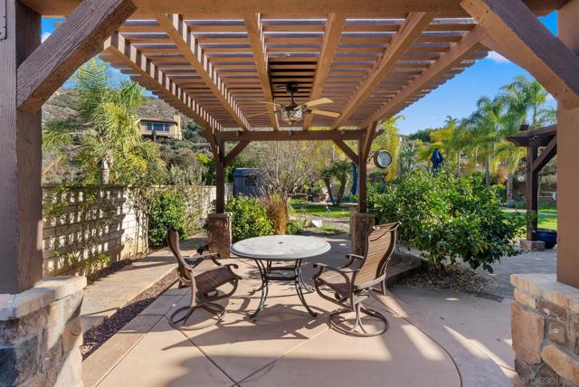 outdoor dining area with pergola near the outdoor kitchen bbq space. Mature meyer lemon and organge trees producing fantastic fruit.