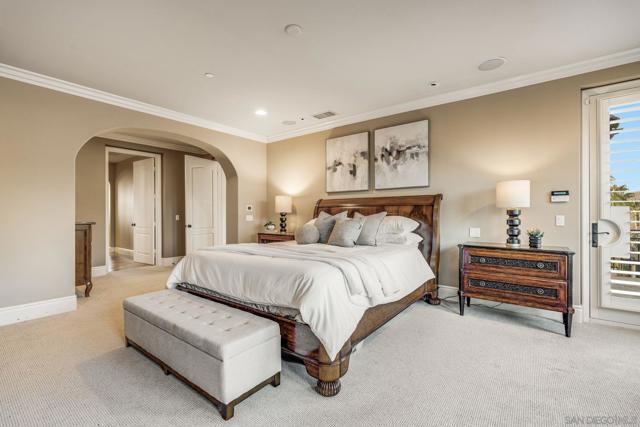 Spacious primary suite with stunning views, abundant natural light, and a cozy sitting area. Plantation shutters and elegant finishes create a serene retreat.