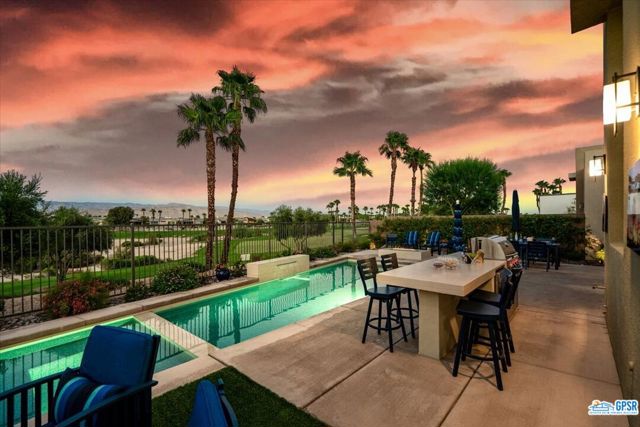 1130 Celadon Street Palm Springs, California This highly upgraded and customized Escena home is sited on a premium golf course lot with spectacular golf course and mountain views!! This 3 bedroom plus den and separate powder room will dazzle you from the moment you enter, from the ultra high end finishes to the outstanding views. The living room features a fireplace with a customized glass hearth, built in wet bar, and 16 foot bifold doors that opens to your covered patio with fire pit. The gourmet kitchen was redesigned to include black stainless appliances, double sinks and a customized pantry. All bedrooms are ensuite with walk in closets designed by California Closets. A designer finished powder room was added for your guests convenience. The outdoor space is an entertainers dream. The salt water/pebble tech pool and spa were enlarged and have been augmented by a water feature and tanning shelf, while other outdoor features include a built in BBQ, refrigerator, eat in bar, landscape lighting and more. Additional upgrades include leased solar panels, control 4 system, garage with built in cabinets, wet bar, electronic window treatments, water filtration system, water softener, and so much more. This is a one of a kind home in the highly desirable community of Escena with its own clubhouse, restaurant, golf and dog parks. ********