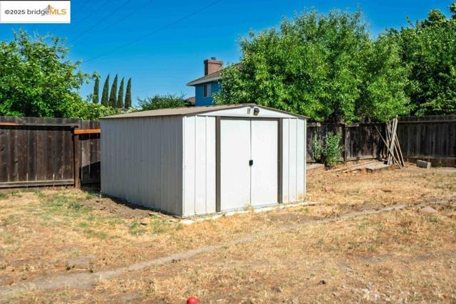 View of shed featuring a fenced backyard