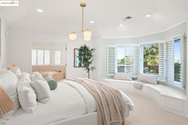 Carpeted bedroom with crown molding and recessed lighting