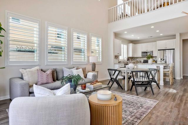 Light, bright living room with views to loft area