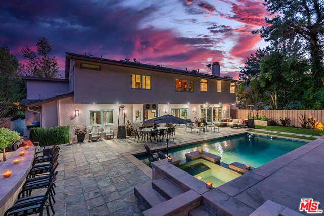9787 Donington Place Beverly Hills, California Come see it like you haven't seen it before! Chic, stylish, and the best value in the BHPO. Beautifully redone 6 bedroom Traditional with a dramatic two-story entry. Formal living room with fireplace seamlessly adjoins to family room, bar and double doors that open to large resort-like yard. Top-of-the-line appliances and features in a gorgeous kitchen to satisfy even the most discriminating Chef. Find the luxurious principal bedroom at the top of the stairs with fireplace, sumptuous bath with dual sinks and dual walk-in closets. Four additional bedrooms upstairs. Entertainers dream yard boasts beautiful landscaping, large swimming pool with spa and fountains, outdoor fireplace and built-in searing BBQ with bar, food warmer, sink and fridge. Absolutely stunning home and move-in ready. Bring your buyers, this will not last!