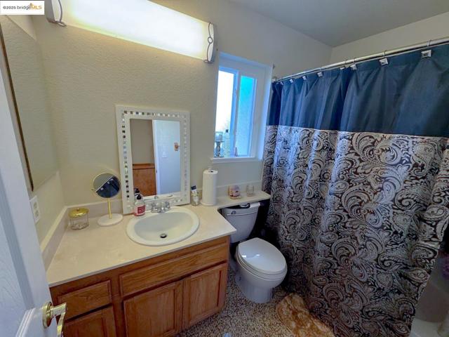 Bathroom with vanity and a shower with curtain