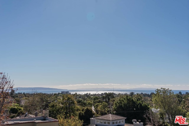 15000 Mc Kendree Avenue Pacific Palisades, California This streamlined mid century home sits above the ABC's, with spectacular views of the ocean to Catalina, city lights and the Queen's necklace. Its proximity to the Palisades village offers easy access to hiking trails, beaches, schools, and Caruso's vibrant center. Downstairs there are two bedrooms with a shared bath, a powder room, and light filled kitchen with a breakfast area. The gracious entertaining spaces with large picture windows invite intimate and grand scale entertaining alike. Upstairs, the master suite with a wrap around deck provides 180-degree views over the village to the ocean and down the coast. The lush garden with mature trees is highlighted by a travertine entertaining patio with a fire pit and ambient lighting, large lawn area and a multi purpose patio area, suitable for al fresco dining, quiet reflection or a sport court. This is an exceptional property with privacy and potential; an opportunity to move right in to a home with room to grow.