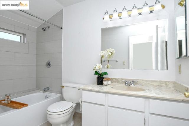 Bathroom with shower / washtub combination and vanity