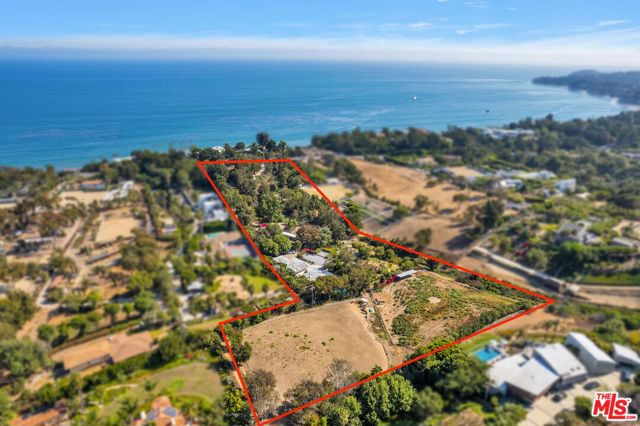 An extraordinary opportunity rarely seen in Malibu! These 9+ acres have ocean views, a private entrance from Pacific Coast Highway and four separate legal lots. This property has so many possibilities - build 4 homes, an equestrian paradise, or create one of the most expansive and beautiful estates Malibu has ever seen. Located across from Escondido Beach and situated in an estate area of Malibu, two of the properties have charming single-family original ranch-style homes and the land is home to goats, peacocks, chickens and horses. Orchards, gardens, a pond, barn, privacy and very favorable topography makes this offering one-of-a-kind.  Each lot consists of approximately 2 acres or more with the configuration as follows: 27473 PCH is a 4 bedroom, 4 1/2 bathroom home on 2 acres with pool; APN 4460-008-014 is a 1.99 acre parcel; 27469 PCH is a 3 bedroom, 2 1/2 bathroom home on 2.58 acres and APN 4460-004-011 (which has paved access off of Winding Way) is 2.54 acres.