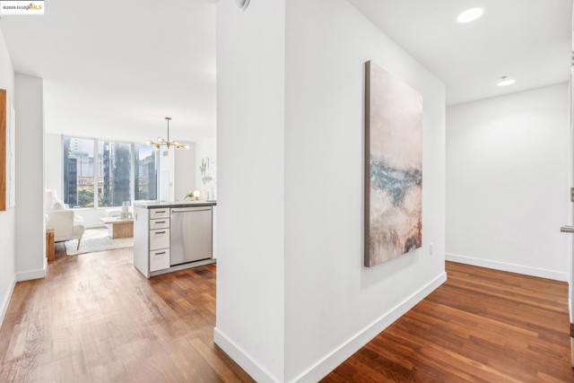 Hall with wood finished floors, a chandelier, and recessed lighting