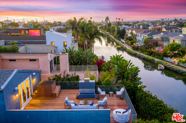 3001 Grand Canal Venice, California The quintessential Venice Canals home is finally available for you! Boasting sweeping views of the Venice canals, this architectural home has everything you need to fully immerse yourself in the Venice lifestyle. Overlooking the famous Venice canals and located just three blocks from the beach, this home features a carefully curated open floor plan on the main level. The bottom floor details an incredible custom chefs kitchen with a restaurant grade range/oven, dual sinks, a Sub-zero fridge and a large breakfast island. The dining room includes a custom table to seat up to twelve and opens up to an entertaining space facing the canals with a built in bar. Continue upstairs to find four bedrooms and three bathrooms. The master bedroom suite features high ceilings, a full walk-in closet, and a large ensuite bathroom. A massive deck off the master bedroom features a Japanese style soaking tub, a gas fire pit and unobstructed views of the Venice Canals. Work from home in the fully built out office which includes and extra long custom desk and large built in bookshelves. Additional features include an outdoor shower, direct access to the canals, and a spacious two car garage with ample cabinet space. The two car driveway provides space for your guests as well. This ultimate Venice Canals home genuinely has it all.
