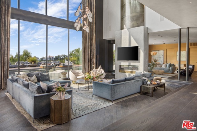 9152 Janice Place Beverly Hills, California Private gated home of John Legend and Chrissy Teigen, one of the worlds most stylish celebrity couples. The grandeur begins in the parlor, w/ its 33-foot ceilings and sculptural staircase, & continues in the extraordinary living room, where floor-to-ceiling windows offer sweeping canyon views. Bespoke patterned ceilings from Thailand, cerused oak floors and clay & steel-rolled walls exude sensuality. The chefs kitchen befits a culinary influencer & cookbook author, 7 opens onto a large family room. The master bedroom features a brass & concrete fireplace, a balcony, a lush Glam Room, & exquisite, newly designed closets evocative of a Chanel showroom. A marble Teuco tub, onyx sinks & a double shower are the stars of the master bath. The design language continues in the backyard, with its heated saltwater pool and jacuzzi, wood-burning oven, chefs grill, & grapevine-wrapped pergola. Solar power and 70kW generator complete the estate. Only moments to The Beverly Hills Hotel and Rodeo.