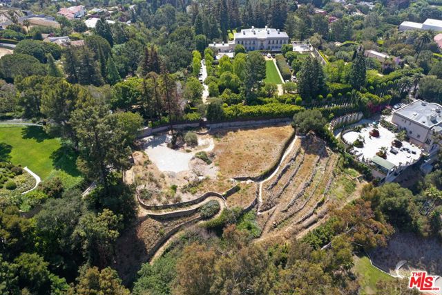 783 Bel Air Road Los Angeles, California Rare opportunity to develop a 21,000-SF estate on a magnificent 1.4-acre lot with sweeping views from Bel-Air to the Pacific Ocean. Designed by SAOTA, a world-renowned architecture firm based out of South Africa. An organic modern architectural marvel that is fully immersed in its picturesque surrounding. Captivating open floor design with an elegant flow and glass sliding windows throughout fills every corner of the home with natural light and the most undisrupted views. 3-story mega-mansion offering the most stunning indoor-outdoor barrierless lifestyle and entertaining features. Its great room, formal dining room, breakfast and den with soaring ceilings open to a sprawling, verdant terrace with zero-edge pool spilling to the LA skyline. Multiple outdoor entertaining areas including lounge terraces and rooftop lounge. World-class amenities include a tennis court and gym. For car aficionados, an oversized subterranean garage, and a show garage. Pajamas lounge with a garden provides a perfect retreat. Leave your mark on one of the most prestigious streets in Bel-Air.