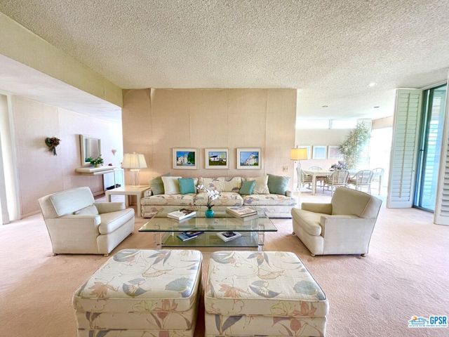 Sellers will entertain all reasonable offers! Designed in 1967 by Richard Harrison, AIA, this unique 2,604 SQFT mid-century 3 bedroom/3 bathroom unit with bonus large den/family room features a gas fireplace flanked by matching large picture windows with bench seats look out to a greenbelt, pool area and sweeping view of the San Jacinto mountains. This unit has not been on the market in over 35 years and has original kitchen/bathroom cabinetry and needs updating and some TLC. Located on golf course and on one of the prime interior cul-de-sacs of the storied private golf community of Seven Lakes Country Club that has been frequented for decades by Hollywood celebrities and where President Dwight Eisenhower hit in only hole-in-one in February1968. Seven Lakes offers the quintessential Palm Springs lifestyle: an executive 18-hole (par 58) Ted Robinson designed course with putting greens, golf pro/pro shop, 15 beautiful pools and spas--most with Ramadas, kitchenettes with grills, tennis/pickleball court, the William Cody clubhouse has a full-service restaurant, bar/lounge, and patio dining overlooks a lake with waterfall/fountain, electric car charging stations, and a 24 hour guarded front gate, and HOA office on the premises, and mature landscape, and only 5 minutes to the Palm Springs Airport. ********