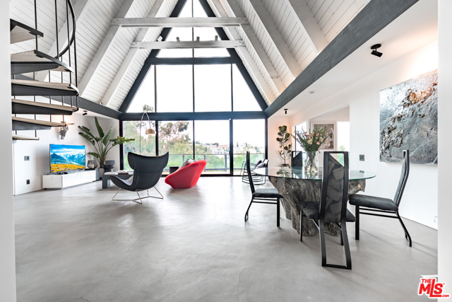 1821 Sunset Plaza Drive Los Angeles, California Tucked away in the hills, but minutes to Sunset Strip this fully-furnished mid-century A-frame is dripping in history and luxury an incredible combination you'd be hard-pressed to find anywhere else. The former popular A-Frame Jazz, this unique home was a well-loved music venue where notable jazz artists performed in the intimate setting of this private residence. While it was thoroughly renovated and upgraded, plenty of attention was given to preserving these unique home original beauty with particular concentration to ensuring the style of the furniture and finishes offers luxury and comfort. Floor-to-ceiling wall of windows allows you to take full advantage of the panoramic views of the city lights. The inside offers a thoughtful flow to make entertaining a breeze with a spacious living room, two master suites, and bonus loft area. Outside, an oversized deck spans the entire back of the home to make sure you have every opportunity to appreciate tranquility views.